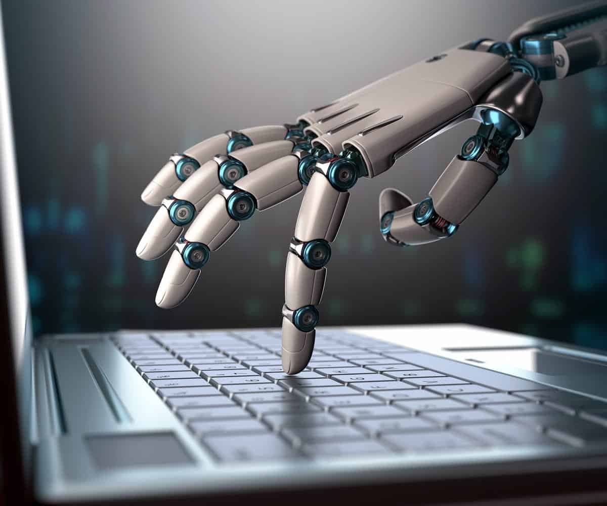 A robot hand typing on a keyboard